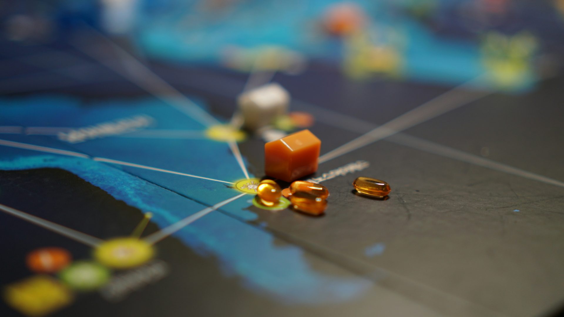 a close up of a game board with pills on it